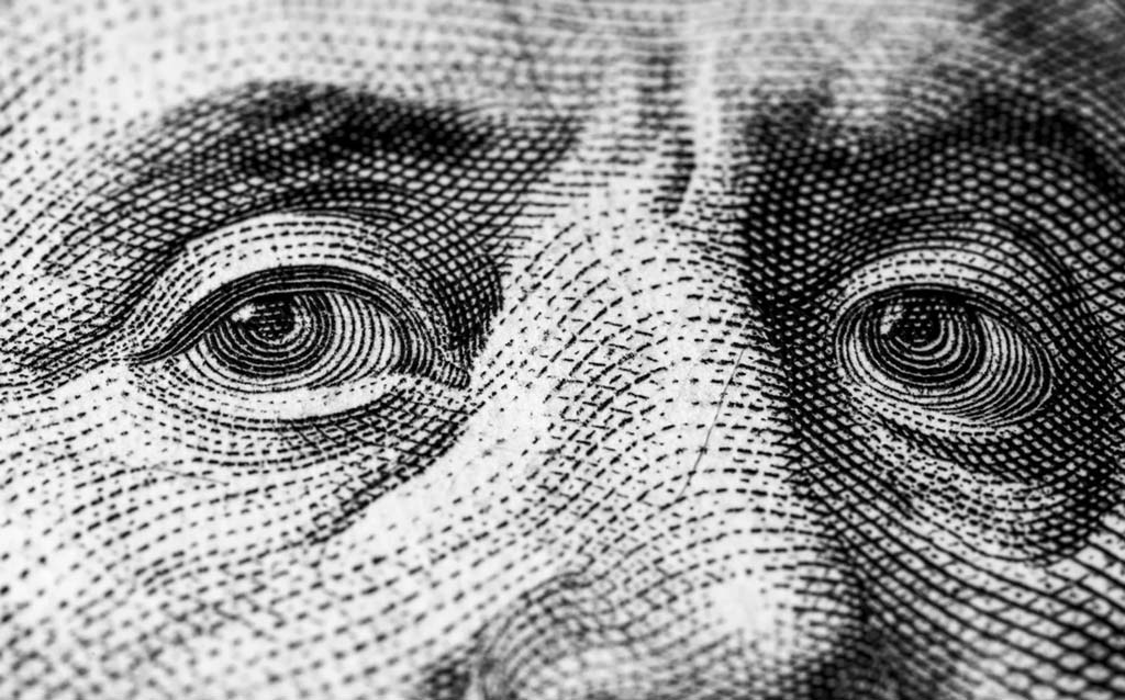 close up of George Washington's eyes from the US one dollar bill